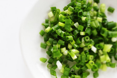 Chopped spring onion on dish with copy space