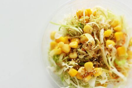 Corn and cabbage salad in plastic lunch packの写真素材