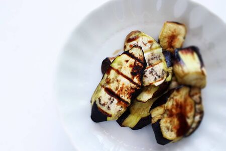 Olive oil and sliced eggplant on dish with copy spaceの写真素材
