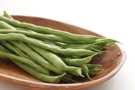 Freshness green bean on wooden plate for healthy food ingredientの写真素材