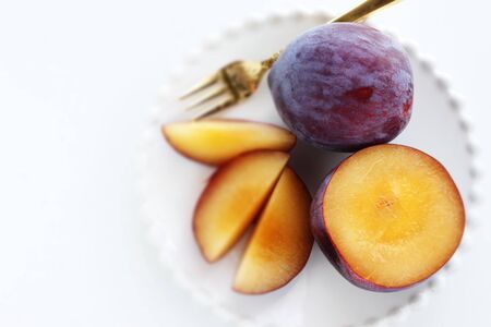 Freshness prune from japan on white dish with copy spaceの写真素材