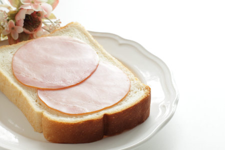 Ham and English bread on dish for breakfastの写真素材