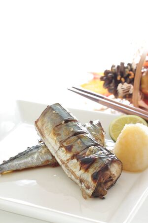 Japanese food, grilled pacific saury fish served with ground radish and lemonの写真素材