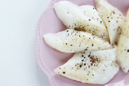 Prepared flat fish and pepper on dish for cooking ingredient