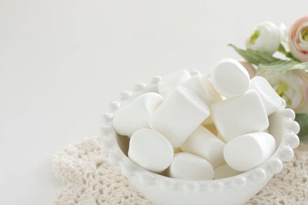 Marshmallow In bowl on white background with copy spaceの写真素材