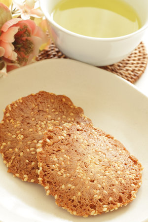 Japanese confectionery, almond nut cracker on dish with teaの写真素材
