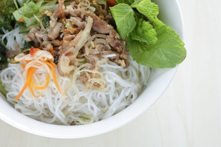 Vietnamese food, rice noodles and grilled pork  served with vegetable and herbal vinegar