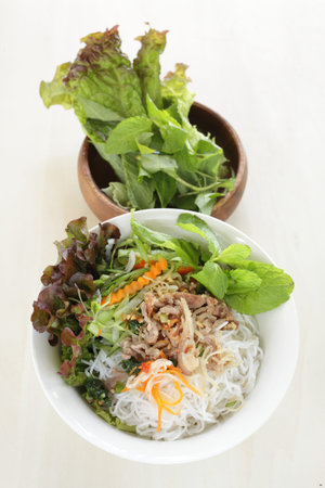 Vietnamese food, rice noodles and grilled pork  served with vegetable and herbal vinegar