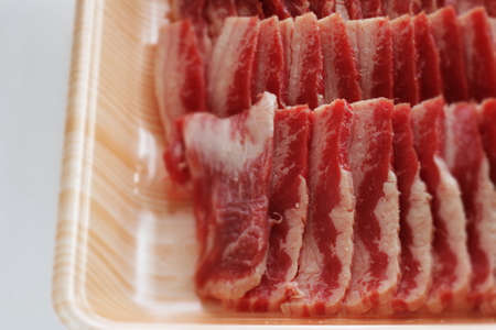 Korean barbecue, sliced marble beef in food containerの写真素材