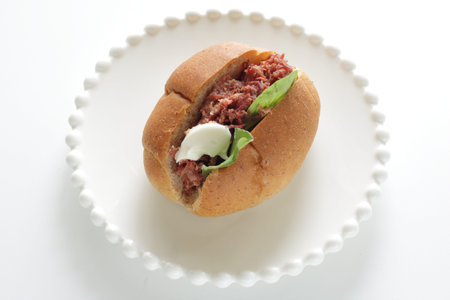 corn beef and cheese bun on white dish