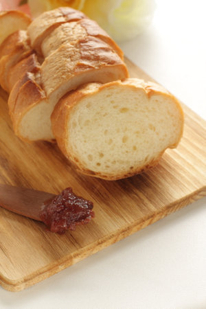 Sliced French bread on wooden cutting boardの写真素材