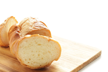 Sliced French bread on wooden cutting board