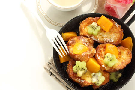 Homemade kiwi fruit and mango with honey on French toastの写真素材