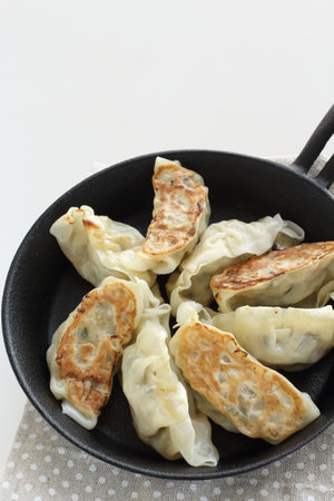 homemade Chinese pan fried Jioazi in skillet panの写真素材