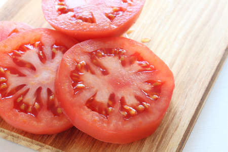 freshness sliced tomato on wooden cutting boardの写真素材