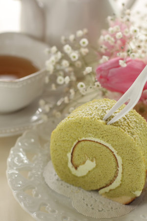 Japanese green tea roll cake on dishの写真素材