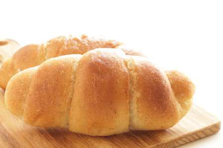 Butter and salt bun on wooden board with copy space