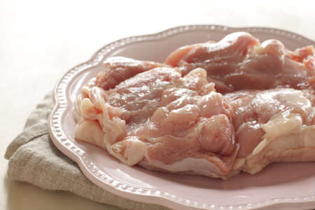 Freshness chicken tight on plate with copy space for cooking ingredientの写真素材