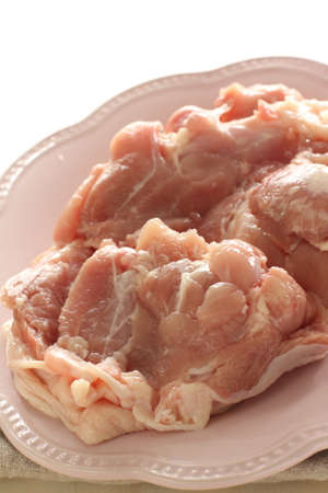Freshness chicken tight on plate with copy space for cooking ingredientの写真素材