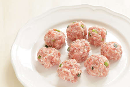 Chinese cooking, minced pork and spring onion ball on plateの写真素材