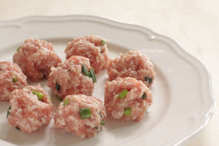 Chinese cooking, minced pork and spring onion ball on plateの写真素材