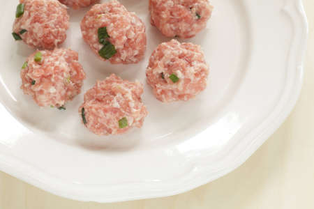 Chinese cooking, minced pork and spring onion ball on plateの写真素材