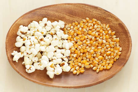 Dried corn on wooden plate for popcorn cooking ingredient imageの写真素材