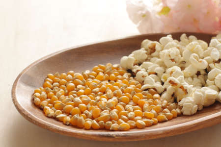 Dried corn on wooden plate for popcorn cooking ingredient imageの写真素材