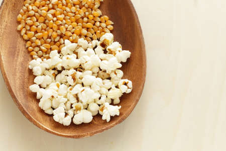 Dried corn on wooden plate for popcorn cooking ingredient imageの写真素材
