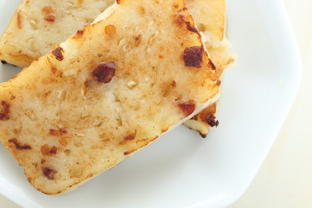 Chinese food, pan fried radish cake on plate with copy spaceの写真素材