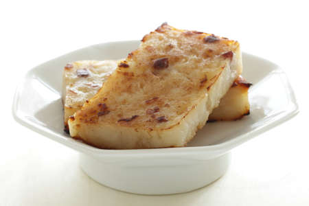 Chinese food, pan fried radish cake on plate with copy spaceの写真素材