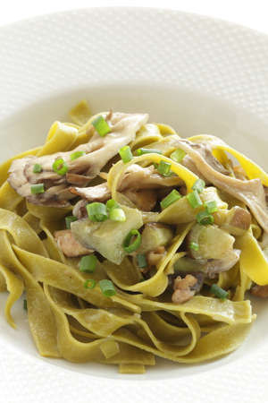 Italian food, Japanese Shimeji mushroom and eggplant in green  spinach fettuccineの写真素材