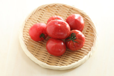 Freshness Japanese tomato in bamboo basket for healthy food ingredientの写真素材