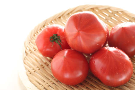 Freshness Japanese tomato in bamboo basket for healthy food ingredientの写真素材