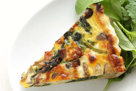 Homemade a piece of mushroom and spinach with bacon quicheの写真素材