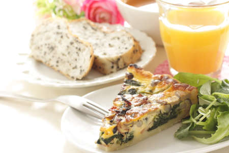 Homemade a piece of mushroom and spinach with bacon quicheの写真素材