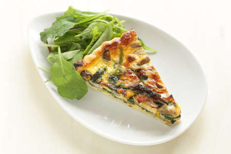Homemade a piece of mushroom and spinach with bacon quicheの写真素材