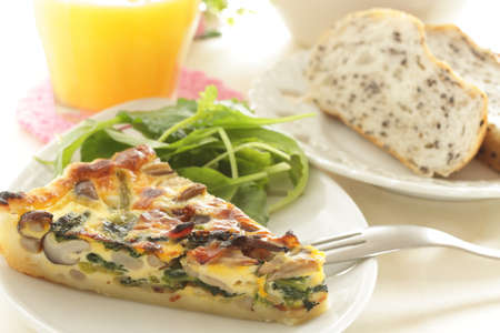 Homemade a piece of mushroom and spinach with bacon quicheの写真素材