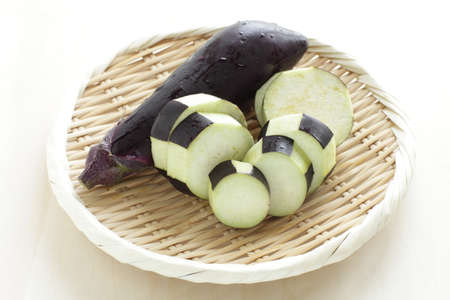 chopped Japanese eggplant on bamboo basket with copy space for cooking ingredientの写真素材