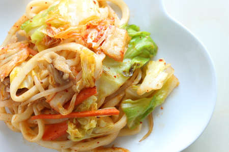 Korean style fried Udon noodles, kimchi and porkの写真素材