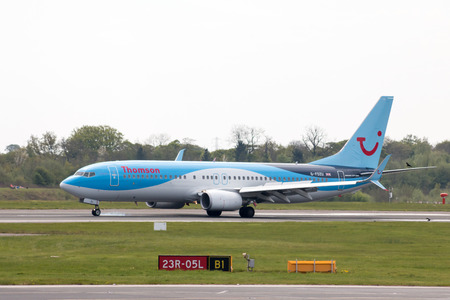 Thomson Airways Boeing 737-8K5 narrow-body passenger plane (G-FDZU) landing to Manchester International Airport runway.のeditorial素材