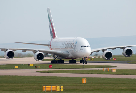 Emirates A380-861 double-decker wide-body passenger plane (A6-EDX) taxiing on Manchester International Airport tarmac.のeditorial素材