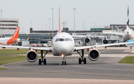 easyJet A320-214 narrow-body passenger plane (G-EZWZ) taxiing on Manchester International Airport tarmac.のeditorial素材