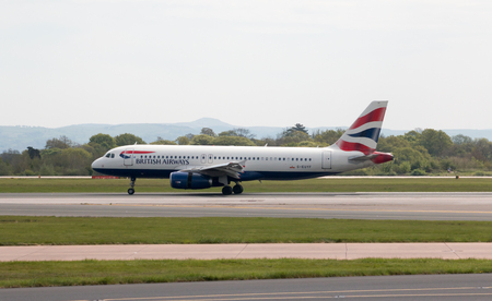 British Airways Airbus A320-232 narrow-body passenger plane (G-EUYF) landing to Manchester International Airport runway.のeditorial素材