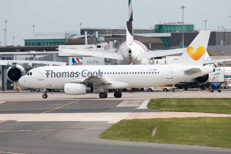 Thomas Cook Airlines Airbus A320-233 narrow-body passenger plane (LY-VEI) taxiing on Manchester International Airport tarmac.のeditorial素材