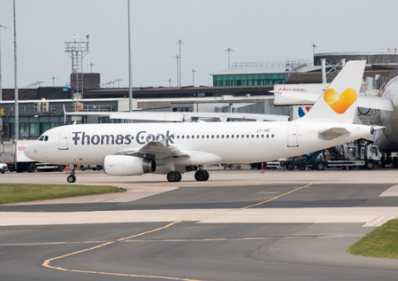Thomas Cook Airlines Airbus A320-233 narrow-body passenger plane (LY-VEI) taxiing on Manchester International Airport tarmac.のeditorial素材