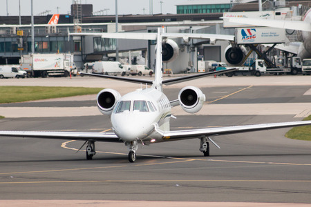 Premium Jet Cessna Citation Excel (Model 560XL) medium-sized business jet  (HB-VOU) taxiing on Manchester International Airport.のeditorial素材