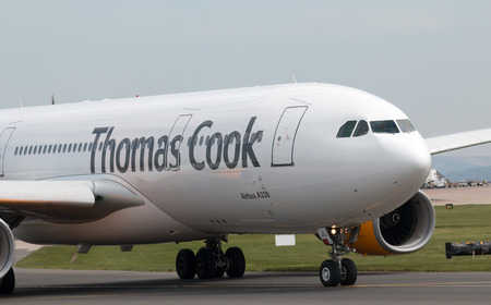Thomas Cook Airlines Airbus A330-243 wide-body passenger plance (G-TCXC) taxiing on Manchester International Airport tarmac.のeditorial素材