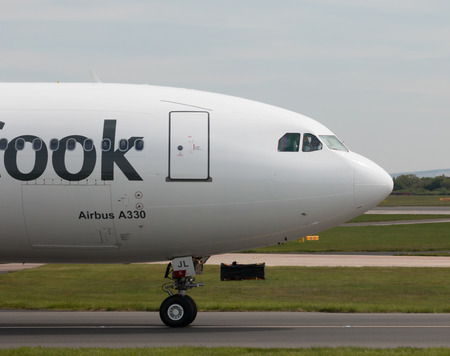 Thomas Cook Airlines Airbus A330-243 wide-body passenger plance (G-TCXC) taxiing on Manchester International Airport tarmac.のeditorial素材