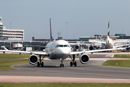Lufthansa A319-100 narrow-body passenger plane (D-AIZY) taxiing on Manchester International Airport tarmac.のeditorial素材
